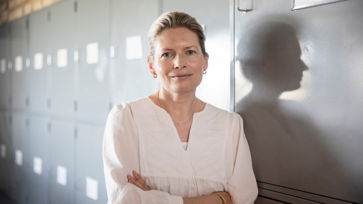 Anna-Liisa looks at the camera inside a University of Helsinki's building.